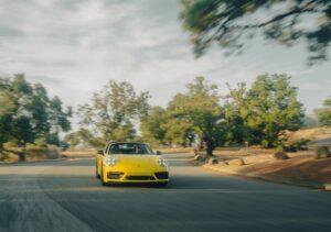 Ein gelber Porsche 911 fährt die Straße hinunter